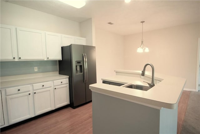 900 Hidden Ridge Ct Unit 202, South Park, PA 15129 - kitchen with stainless steel fridge, a sink, wood finished floors, a center island with sink, and white cabinets