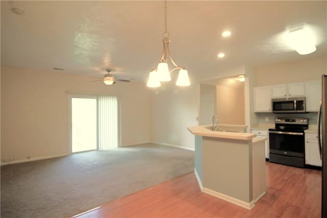 900 Hidden Ridge Ct Unit 202, South Park, PA 15129 - kitchen with stainless steel appliances, white cabinets, baseboards, hanging light fixtures, and recessed lighting