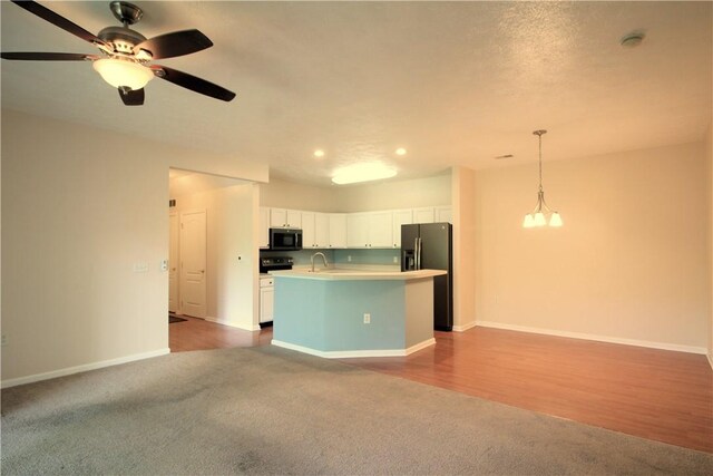 900 Hidden Ridge Ct Unit 202, South Park, PA 15129 - kitchen with black refrigerator with ice dispenser, carpet flooring, open floor plan, light countertops, and white cabinets