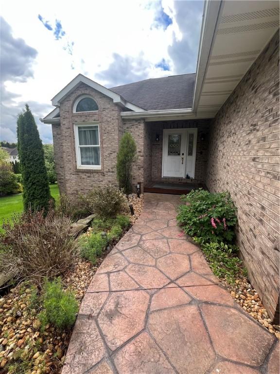 200 Holyoke Rd, Center Twp But, PA 16001 - view of exterior entry with roof with shingles and brick siding