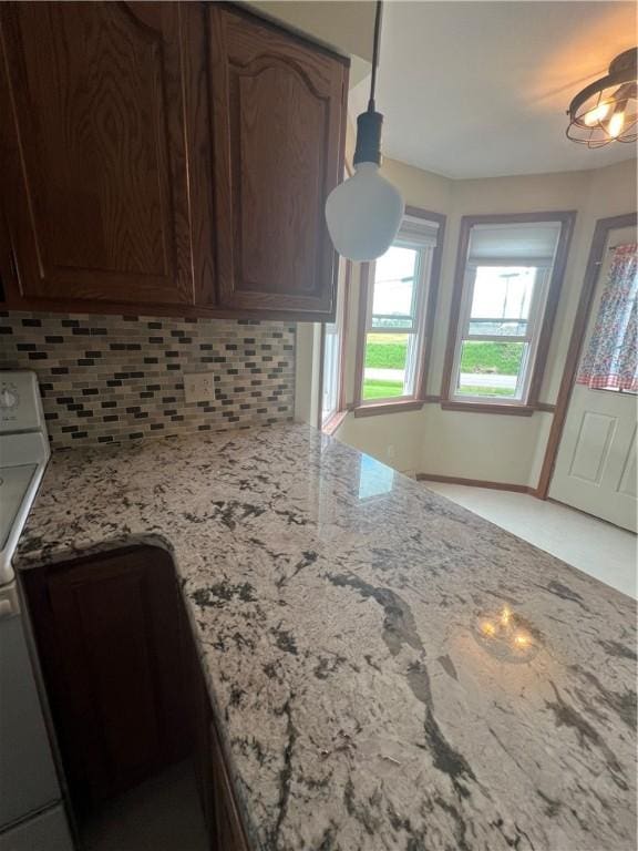 200 Holyoke Rd, Center Twp But, PA 16001 - kitchen featuring backsplash, light stone countertops, and range