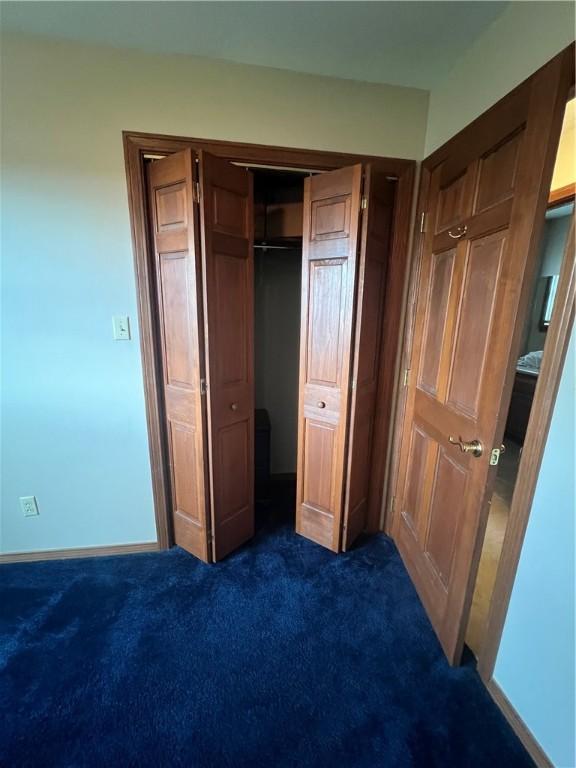 200 Holyoke Rd, Center Twp But, PA 16001 - unfurnished bedroom featuring a closet, dark colored carpet, and baseboards