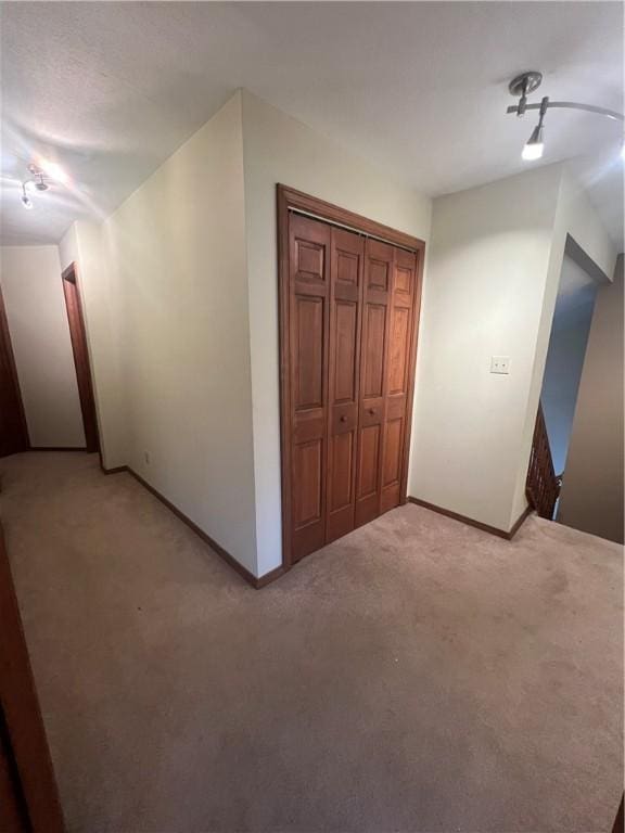 200 Holyoke Rd, Center Twp But, PA 16001 - interior space with baseboards, rail lighting, and light colored carpet