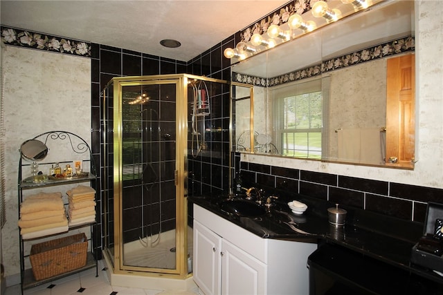 bathroom featuring tile patterned floors, vanity, and a stall shower
