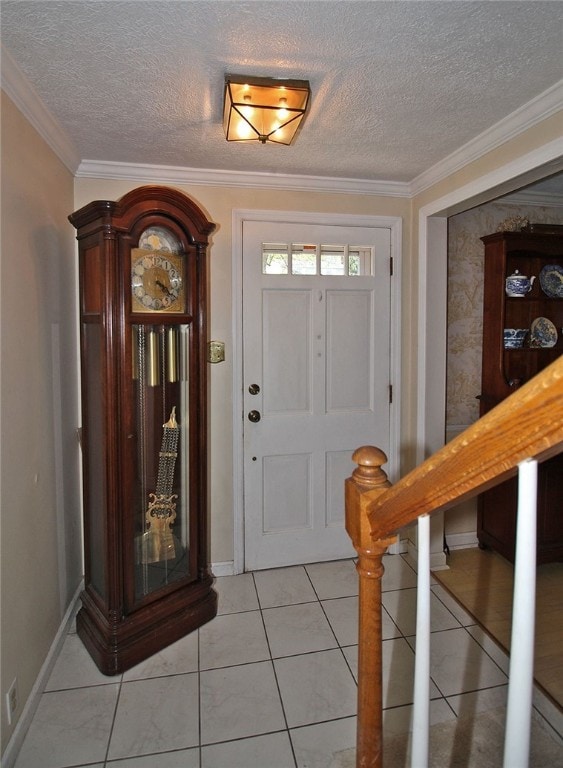 entrance foyer with baseboards, light tile patterned floors, crown molding, and a textured ceiling