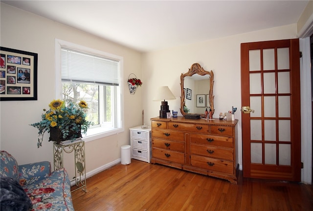 living area with baseboards and light wood finished floors