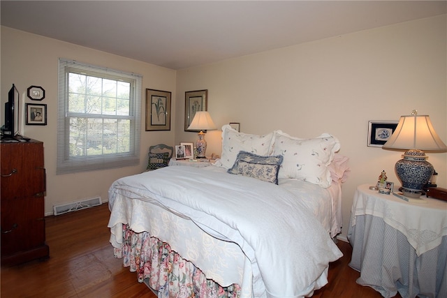 bedroom with visible vents and wood finished floors