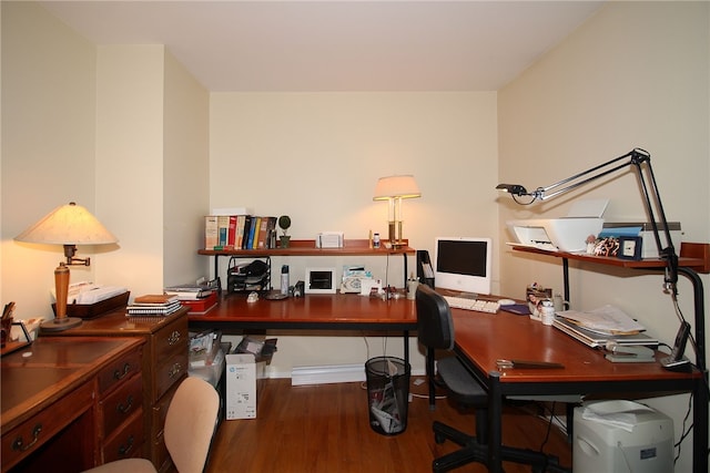 office space featuring baseboards and wood finished floors