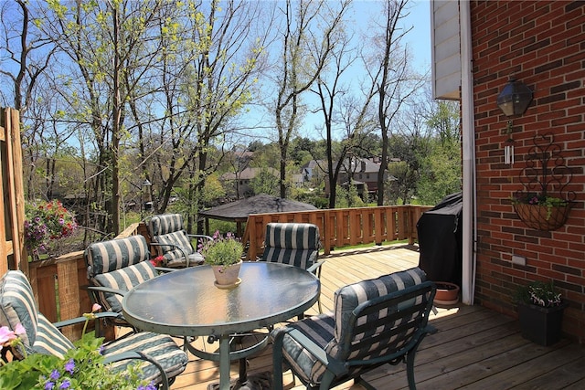 wooden terrace with outdoor dining area