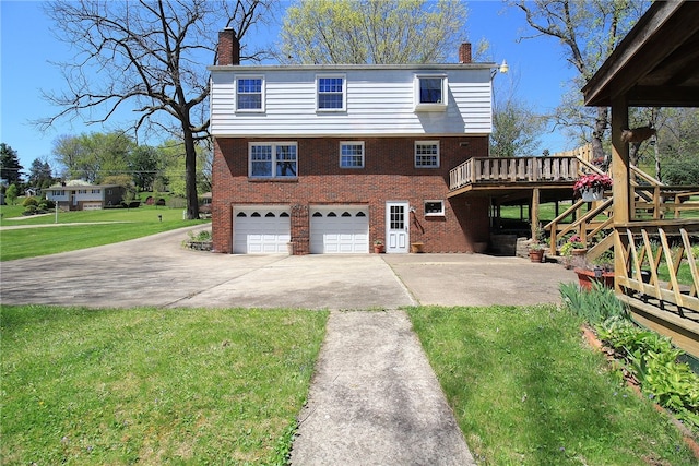 view of front of property with a chimney, a wooden deck, brick siding, and concrete driveway