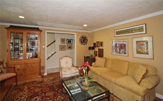 living room with crown molding, stairway, and wood finished floors