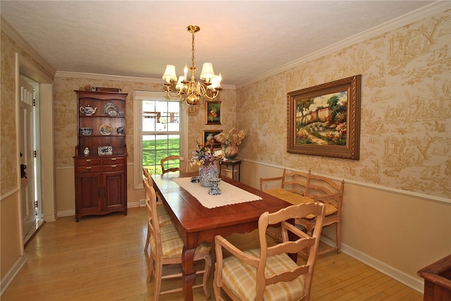 dining space featuring a wainscoted wall, crown molding, a notable chandelier, wallpapered walls, and light wood-style floors