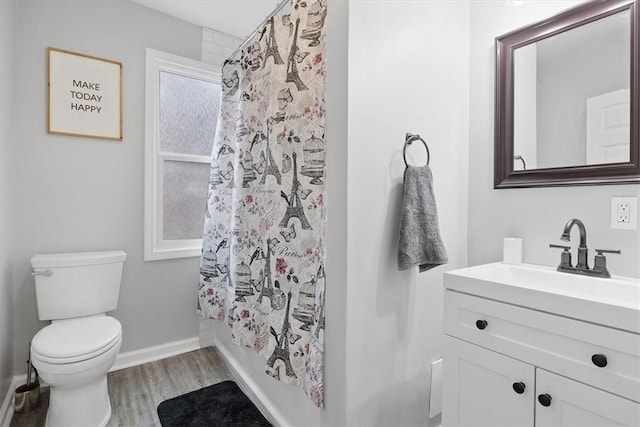 bathroom with toilet, baseboards, vanity, shower / bathtub combination with curtain, and wood finished floors