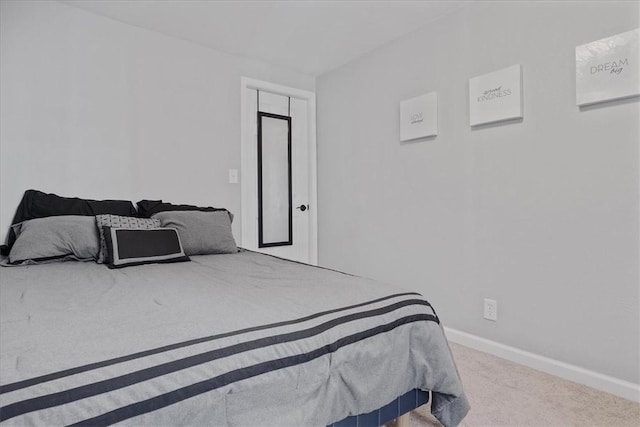carpeted bedroom with baseboards