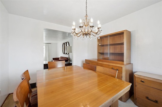 dining space with an inviting chandelier