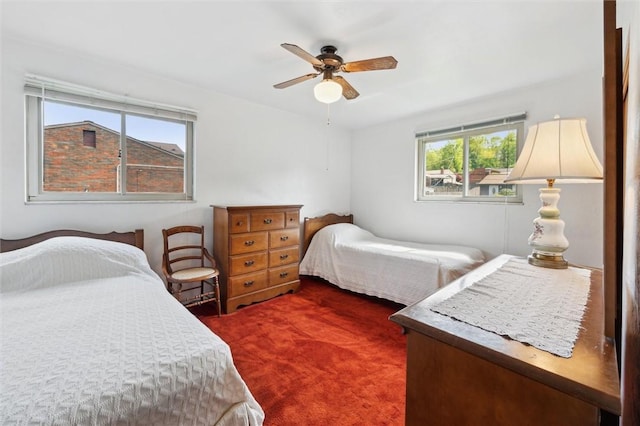 bedroom with a ceiling fan and carpet