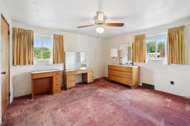 bedroom with light carpet, a ceiling fan, visible vents, and multiple windows