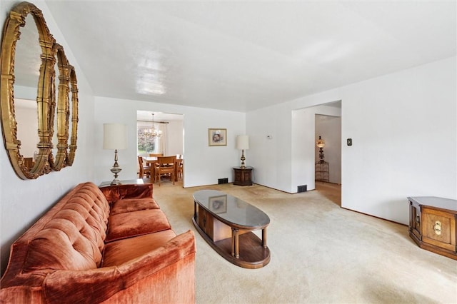 living room featuring an inviting chandelier and light colored carpet