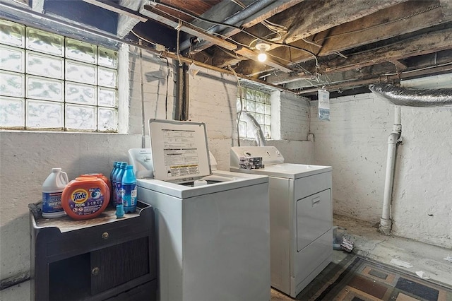 clothes washing area featuring laundry area and washing machine and clothes dryer