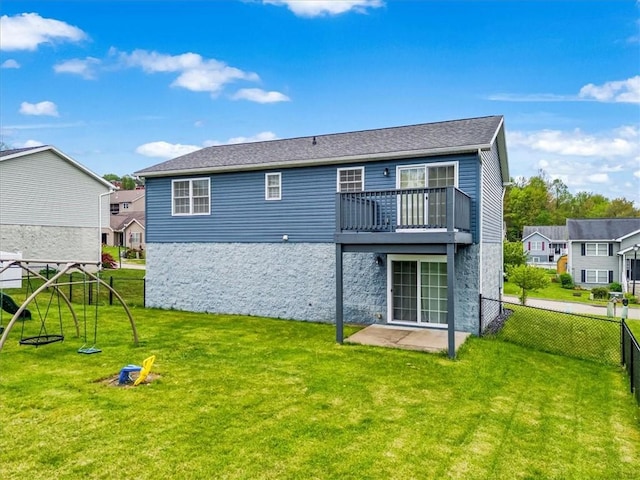 105 Luzerne Ave, South Union Twp, PA 15401 - back of house with fence, stone siding, a balcony, a residential view, and a lawn