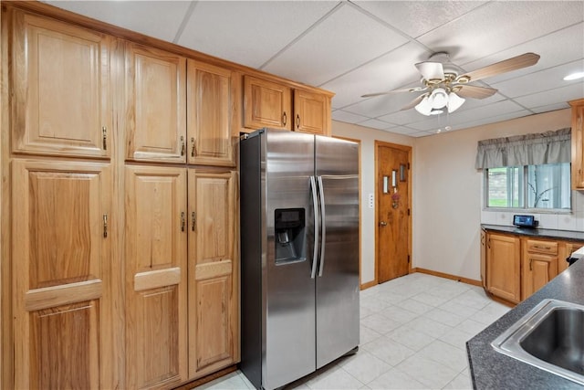 73 Hempstead Ave, West View, PA 15229 - kitchen with light tile patterned floors, a ceiling fan, dark countertops, stainless steel refrigerator with ice dispenser, and baseboards