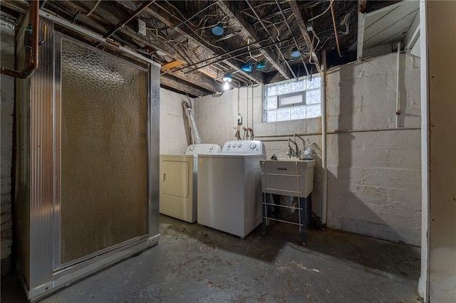 below grade area featuring washer and clothes dryer and a sink
