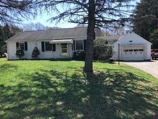 ranch-style home with a front lawn and concrete driveway