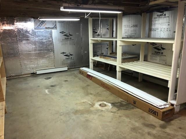 unfinished below grade area featuring a baseboard heating unit