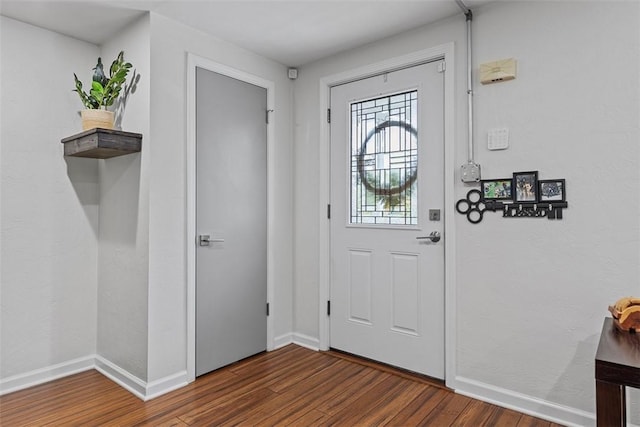 entrance foyer with baseboards and wood finished floors