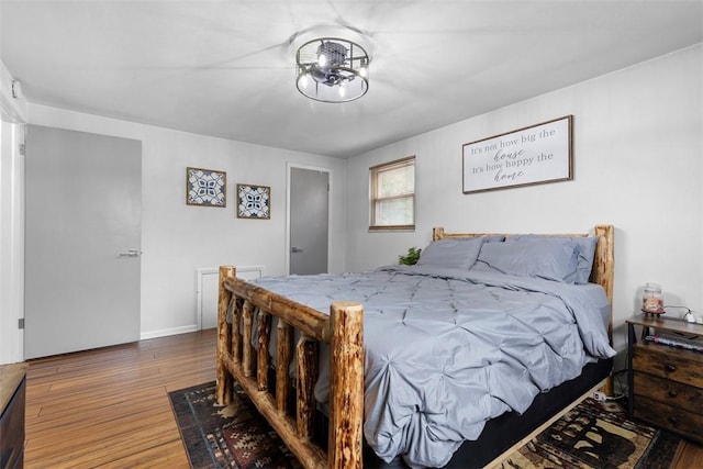 bedroom with baseboards and wood finished floors