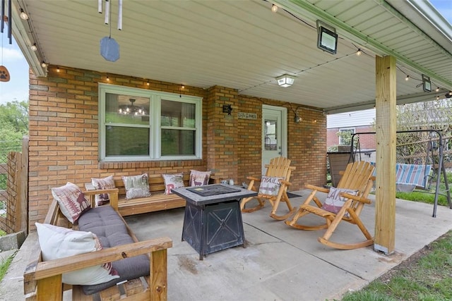 view of patio / terrace with an outdoor living space with a fire pit and fence