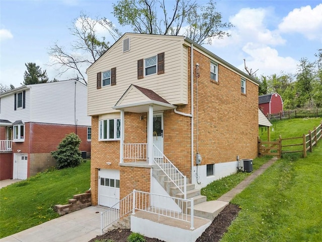 view of front of property with a garage, fence, concrete driveway, a front yard, and brick siding