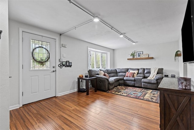 living area featuring wood finished floors and baseboards