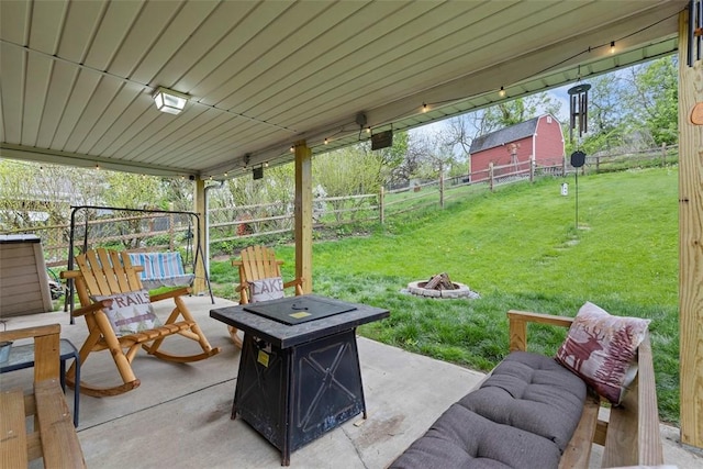view of patio / terrace featuring fence and a fire pit