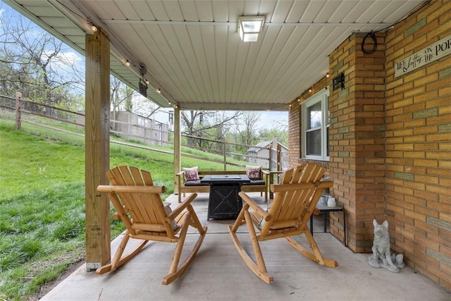 view of patio with a fire pit and fence