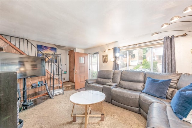 living area with stairs and carpet floors