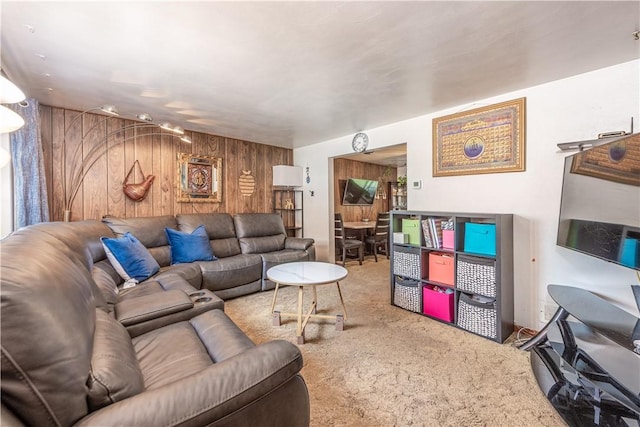living area with wooden walls and carpet floors