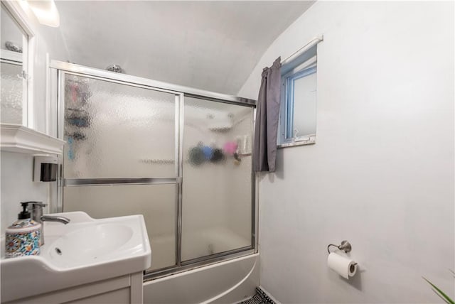 bathroom with vanity and shower / bath combination with glass door