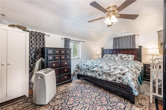 bedroom featuring a ceiling fan and lofted ceiling