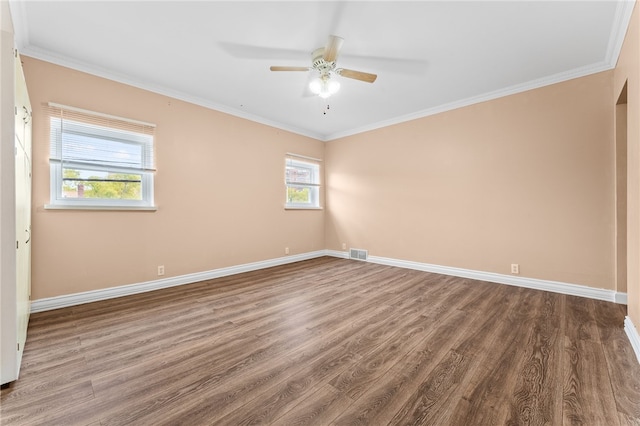 unfurnished room featuring baseboards, visible vents, wood finished floors, and a ceiling fan