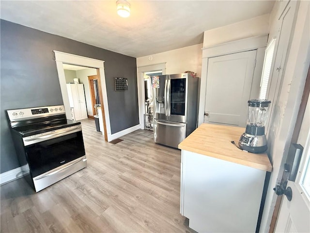 1415 E Washington St, New Castle/4Th, PA 16101 - kitchen featuring baseboards, wooden counters, stainless steel appliances, and light wood-type flooring