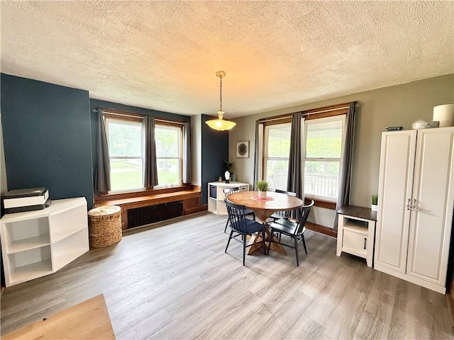 1415 E Washington St, New Castle/4Th, PA 16101 - dining space featuring radiator, light wood-style flooring, and a textured ceiling