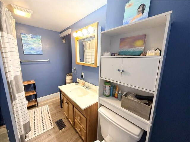 1415 E Washington St, New Castle/4Th, PA 16101 - bathroom featuring toilet, wood finished floors, visible vents, baseboards, and vanity