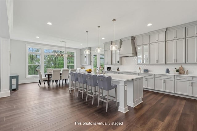 2023 Caymus Ct, Marshall, PA 15005 - kitchen with custom exhaust hood, recessed lighting, a kitchen breakfast bar, dark wood-style flooring, and a center island with sink