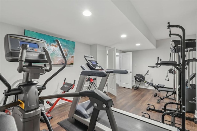 exercise room featuring wood finished floors, baseboards, and recessed lighting