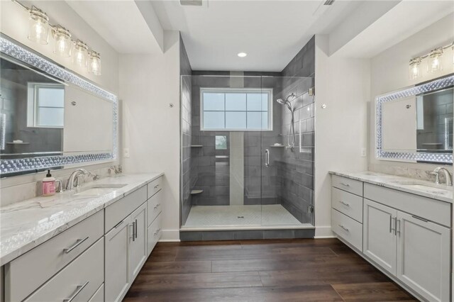 2023 Caymus Ct, Marshall, PA 15005 - bathroom with a stall shower, two vanities, wood finished floors, and recessed lighting