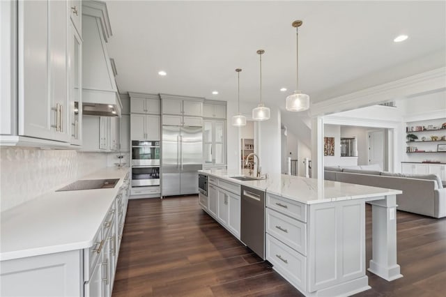 kitchen featuring a sink, recessed lighting, dark wood-type flooring, and appliances with stainless steel finishes