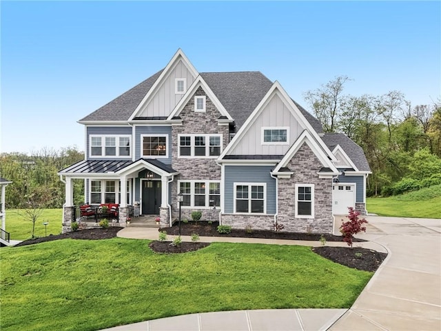 craftsman house with board and batten siding, driveway, stone siding, a porch, and a front lawn