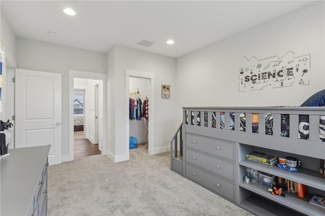 carpeted bedroom with a closet, recessed lighting, baseboards, visible vents, and a spacious closet