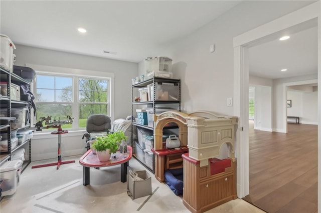 living area with visible vents and recessed lighting